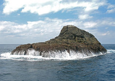 A solitary island in the distant ocean, Sandon Iwa Rocks.