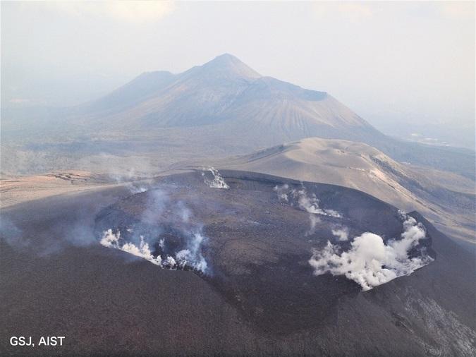 2018年3月14日　霧島山新燃岳北西側上空より。手前の舌状の部分が火口縁からあふれ出た溶岩流。奥の山は高千穂峰。